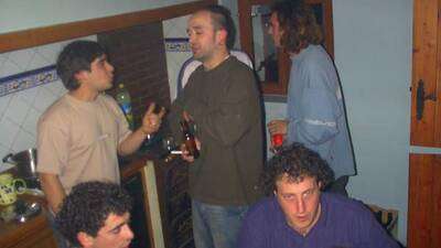 Santi, Alain, Jorge y Ballito dialogan animadamente, acompañados de una copilla de patxaran.